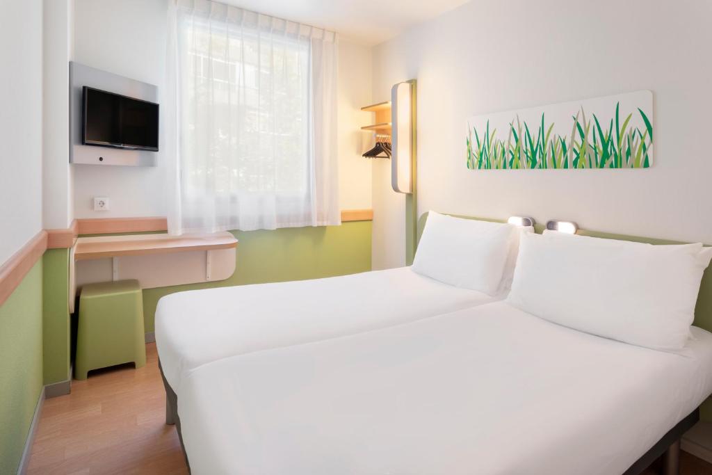 Postel nebo postele na pokoji v ubytování B&B HOTEL Zaragoza Plaza Mozart