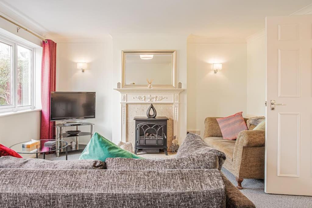 a living room with a couch and a fireplace at Central 2 Bed House w/ Garden and Free Parking! in Cheltenham