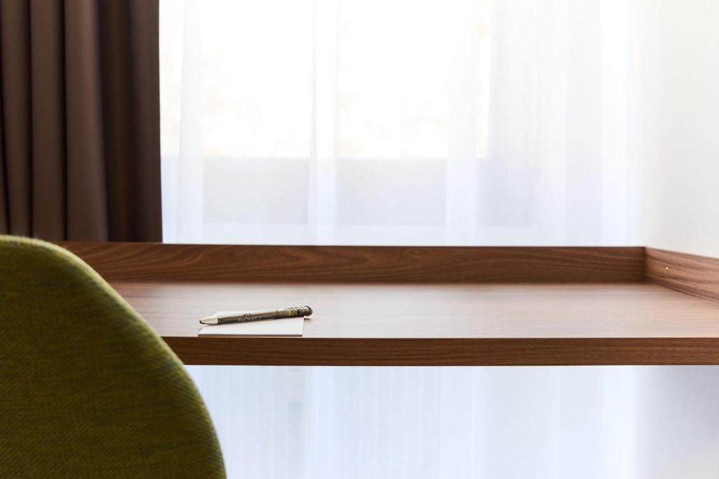 a pen sitting on a desk next to a window at Hotel Rhönkitz in Bad Kissingen