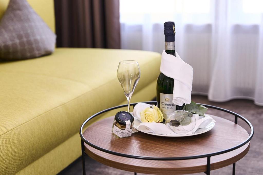 a bottle of wine and a glass on a table at Hotel Rhönkitz in Bad Kissingen