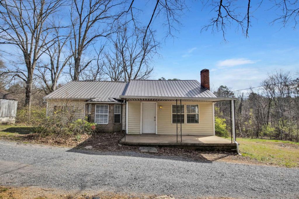 a small white house with a tin roof at Pleasant Hill Home in Wooddale