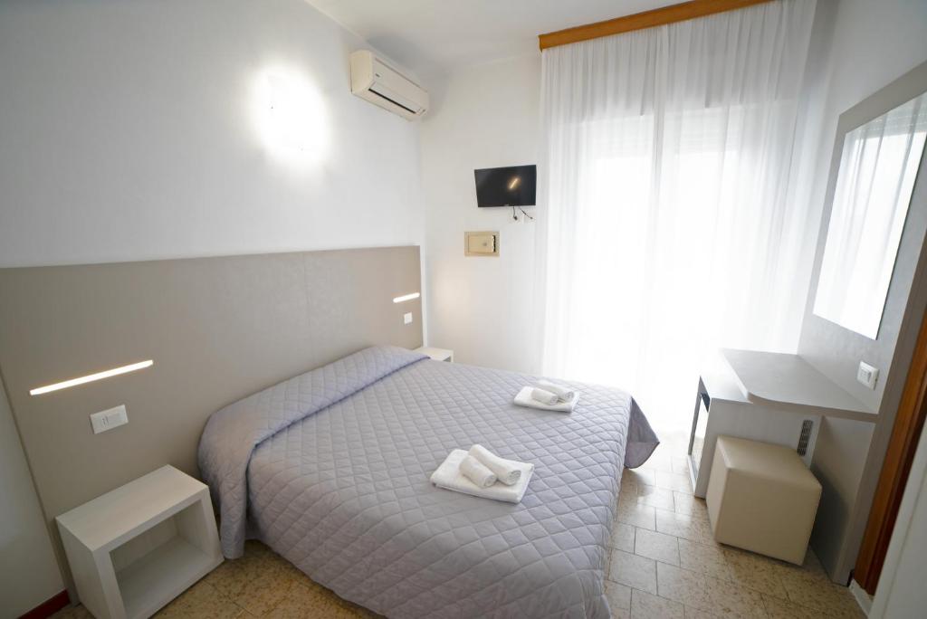 Postel nebo postele na pokoji v ubytování Hotel Ischia