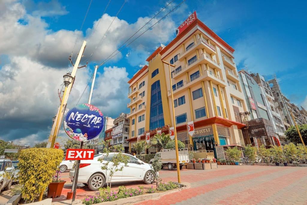 a white car parked in front of a hotel at HK Clarks Inn, Amritsar in Amritsar