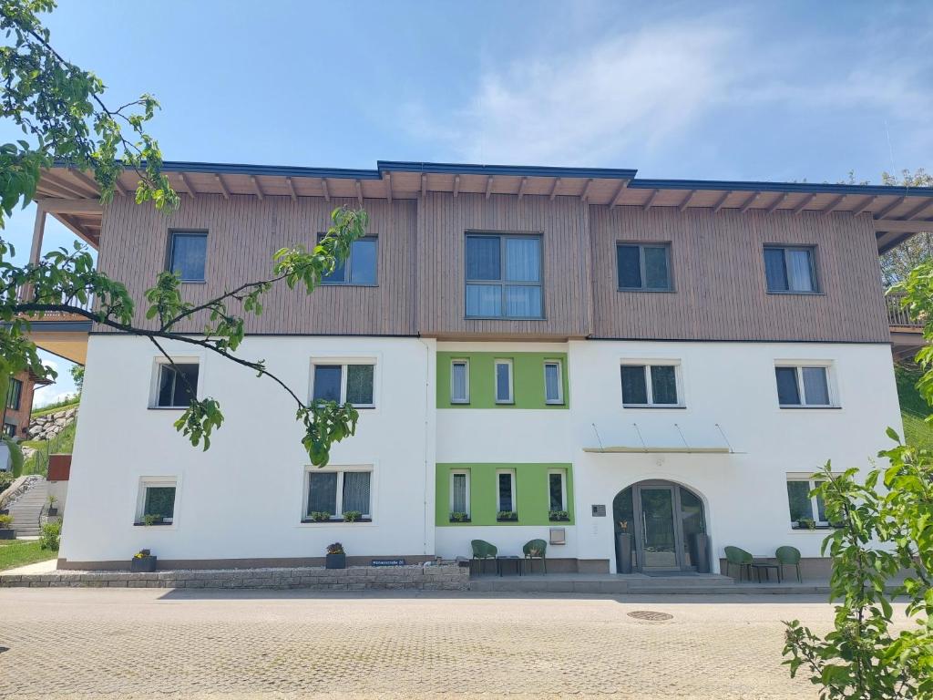 a large white building with a wooden roof at Laudach INN in Vorchdorf