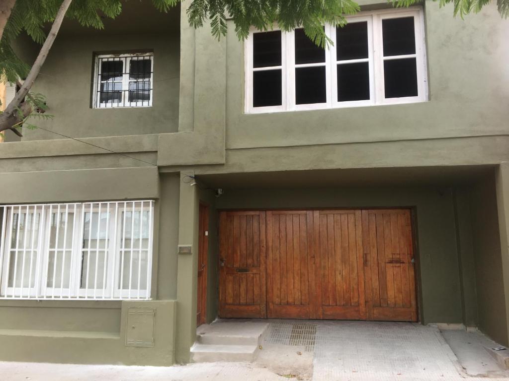 a house with a wooden door and two windows at Residencia La Isabel in San Luis