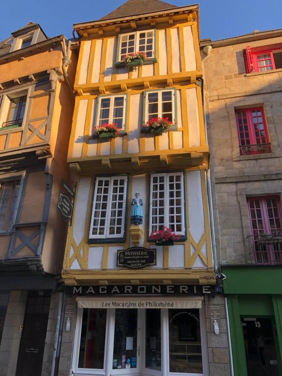 a yellow and white building with windows and flowers at Ty Kaz Old Kemper in Quimper