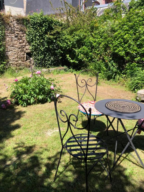 a table and chair sitting in the grass at Ty Kaz Old Kemper in Quimper