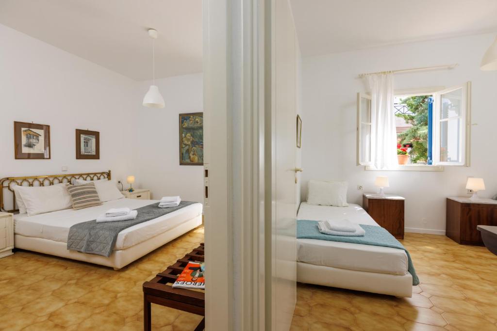 a bedroom with two beds and a window at Villa in the Garden in Kokkini Khanion