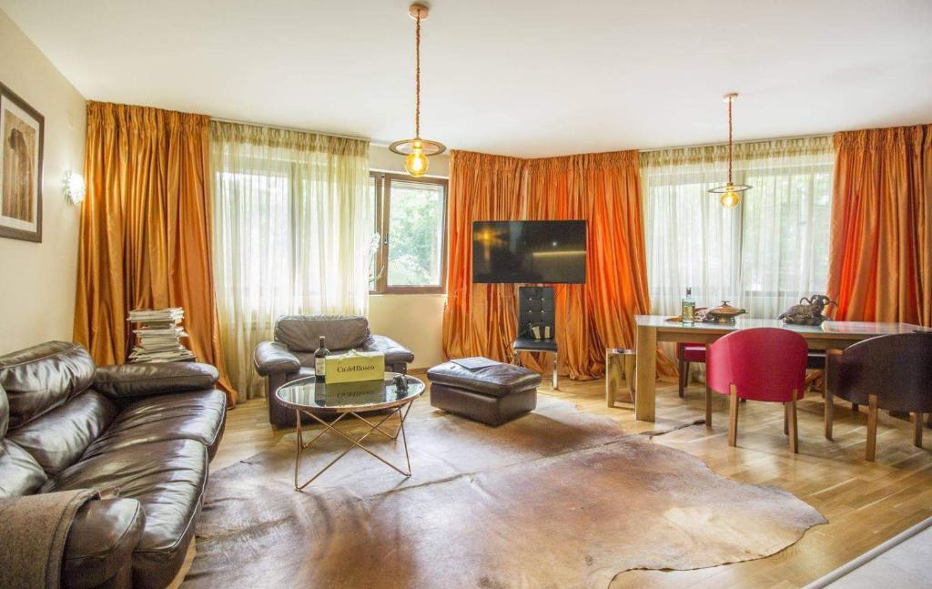 a living room with a couch and a table at Тorino luxury с гараж in Sofia