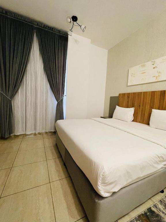 Postel nebo postele na pokoji v ubytování Husin Al Khaleej Hotel Apartment