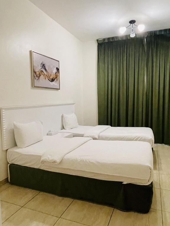 Postel nebo postele na pokoji v ubytování Husin Al Khaleej Hotel Apartment