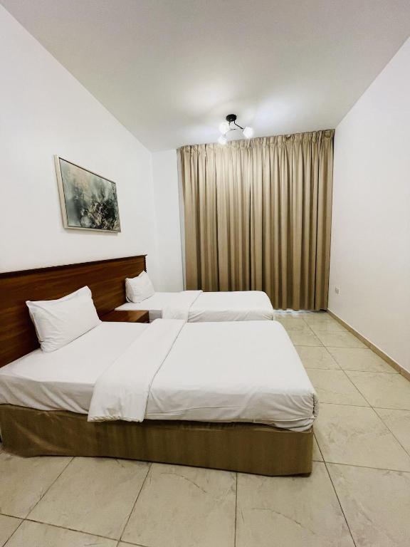 Postel nebo postele na pokoji v ubytování Husin Al Khaleej Hotel Apartment