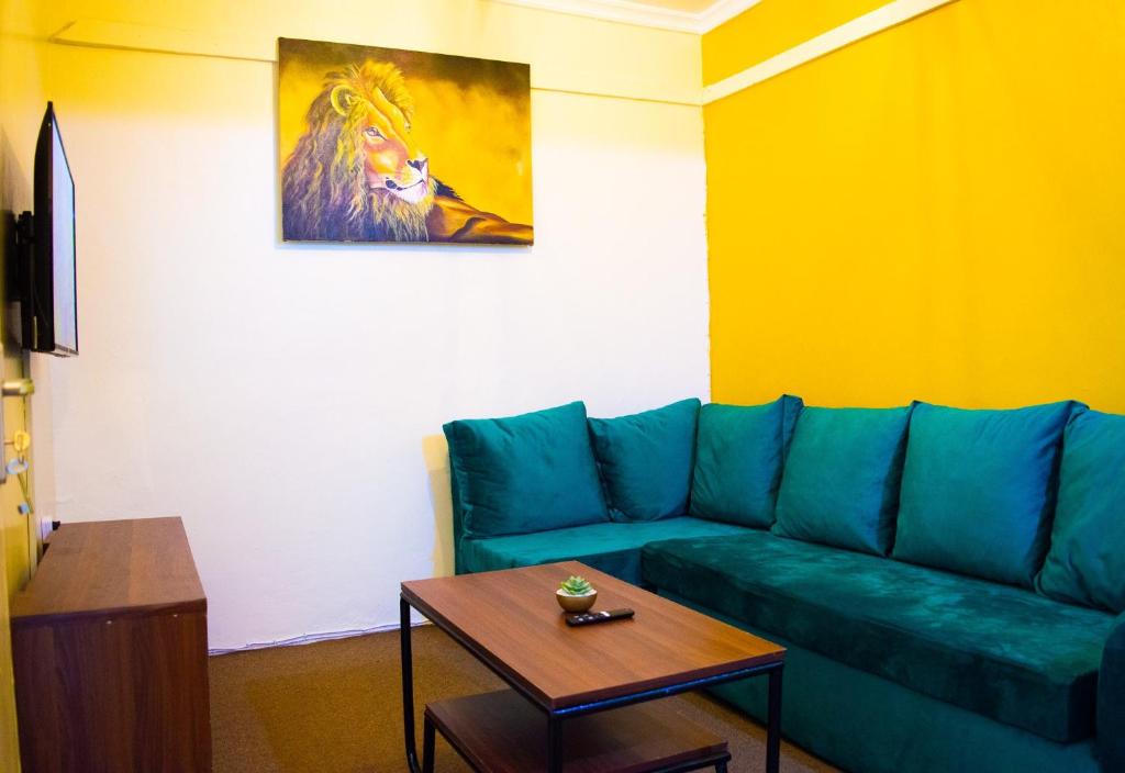 a living room with a green couch and a table at One Bedroom House in Langata in Nairobi