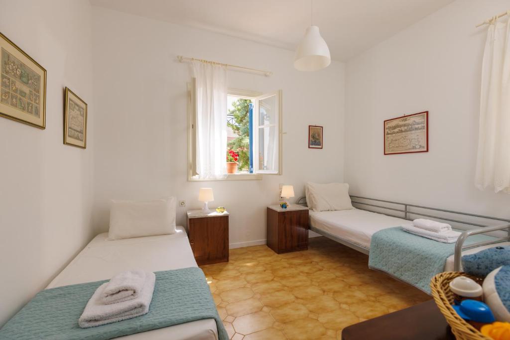 a room with two beds and a window at Villa in the Garden in Kokkini Khanion