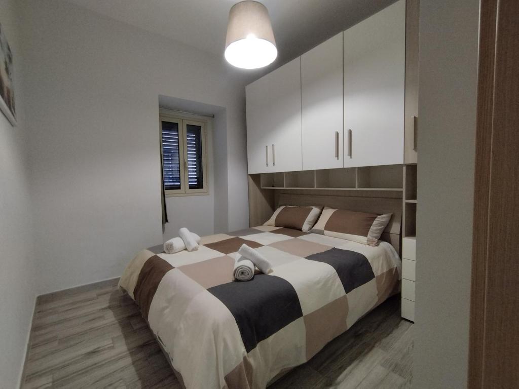 a bedroom with a large bed with white cabinets at Casa Paolina in Militello in Val di Catania