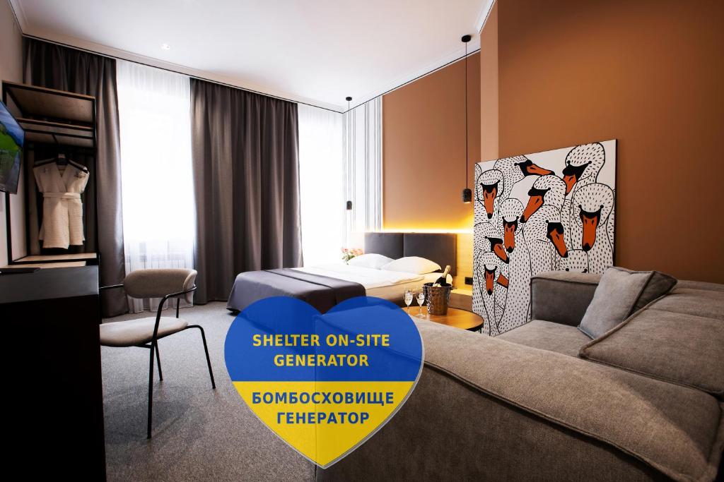 a living room with a couch and a bed in a room at Kulikovskiy hotel in Kharkiv
