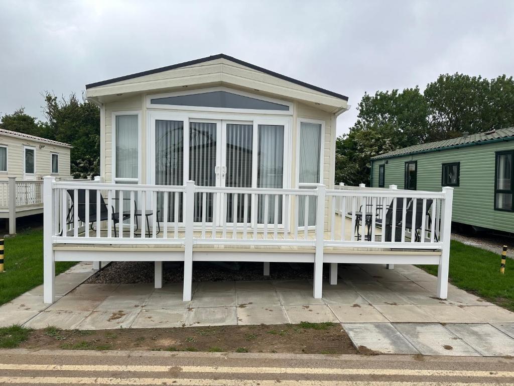 a white porch with chairs on a patio at Ingoldmells Sunnymede I14 in Ingoldmells