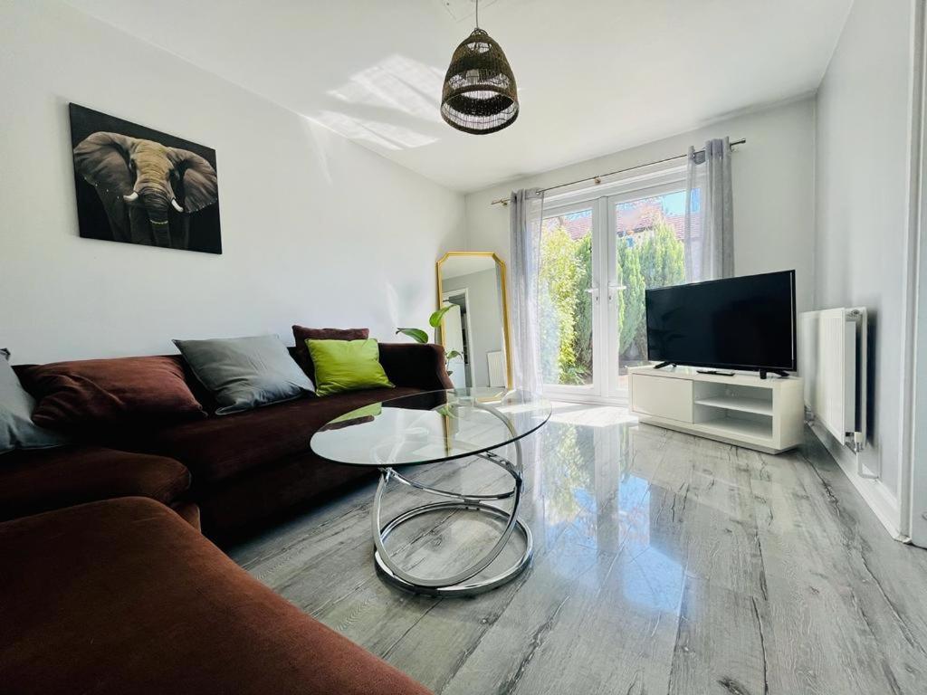 a living room with a couch and a table at Barnstaple Drive House in Manchester