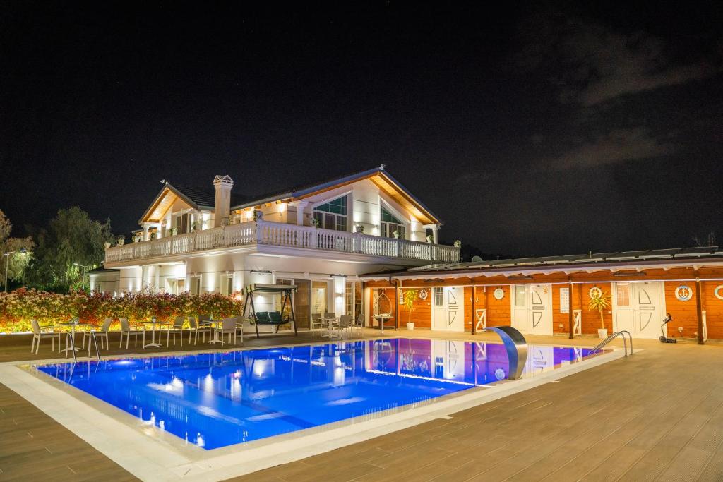 a large house with a swimming pool at night at Villa Bianca in Rubjekë