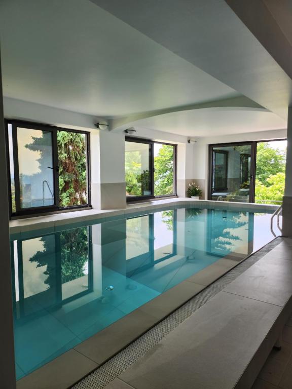 a swimming pool in a house with windows at WOLKENHAWK in Zagreb
