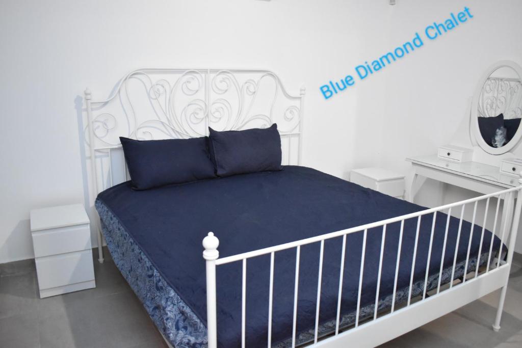 a bedroom with a white bed with a white crib at Blue Diamond in Jerash