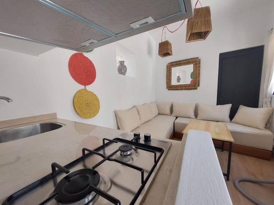 a living room with a stove and a couch at Dar Zwina, Charming and lovely house in Tangier