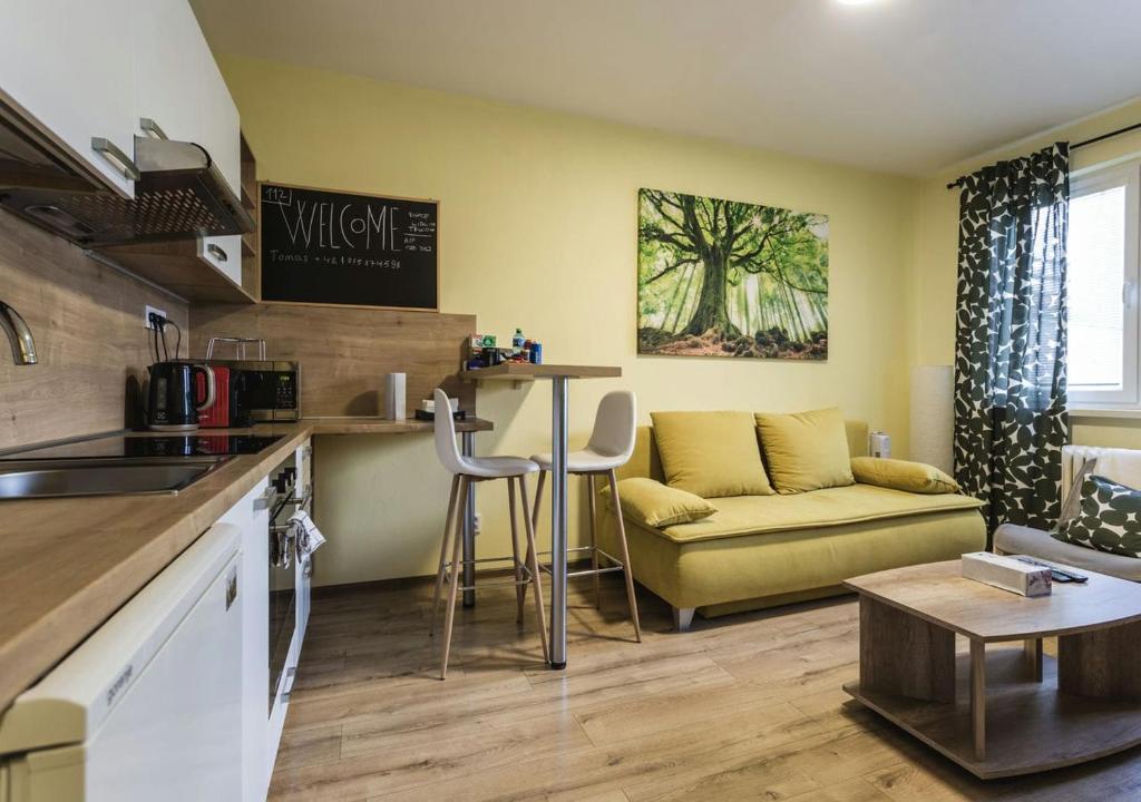 uma cozinha e sala de estar com um sofá e uma mesa em FLEXIHOME SK - Trieda SNP - private parking spot em Košice