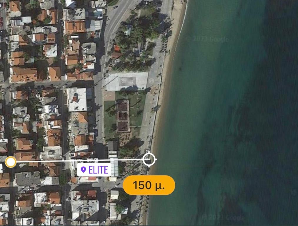 an overhead view of a beach with a orange sign at billys apartment in Nea Peramos