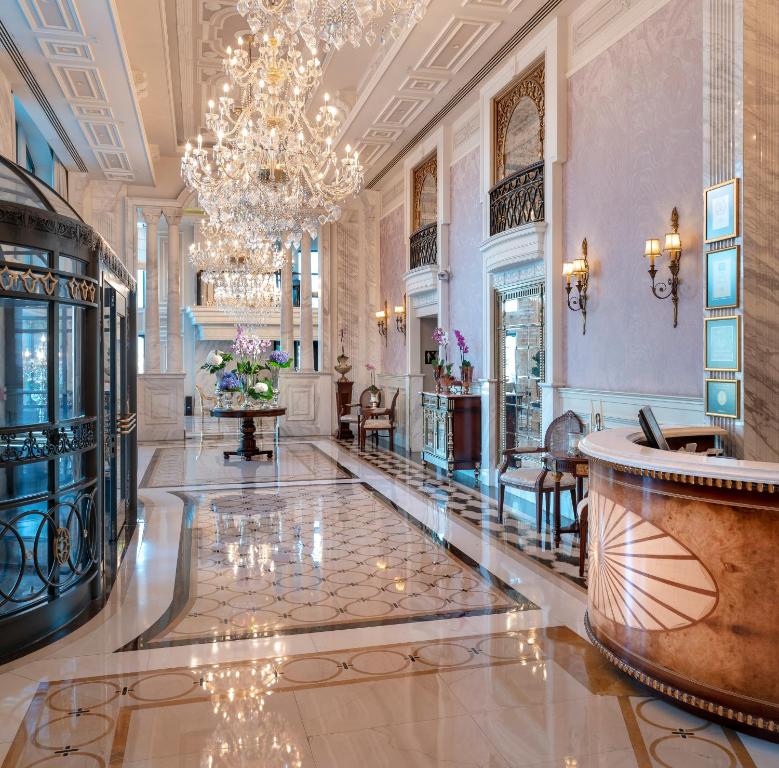 a lobby with a chandelier and a large room at Rixos Pera Istanbul in Istanbul