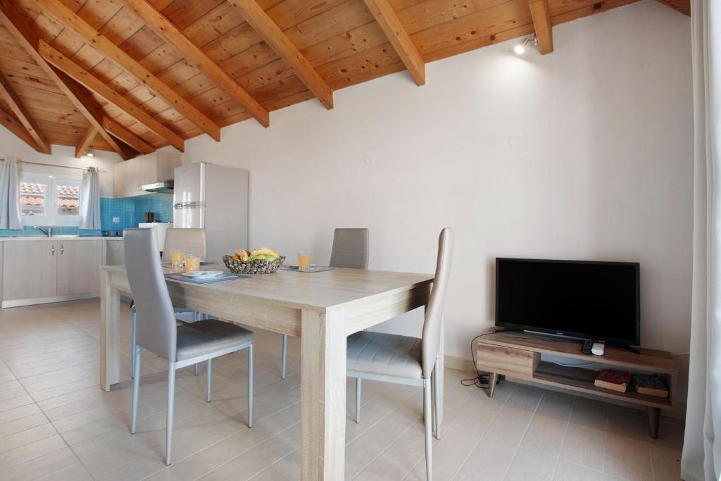 A television and/or entertainment centre at Yiannis Suite with Sea View 10