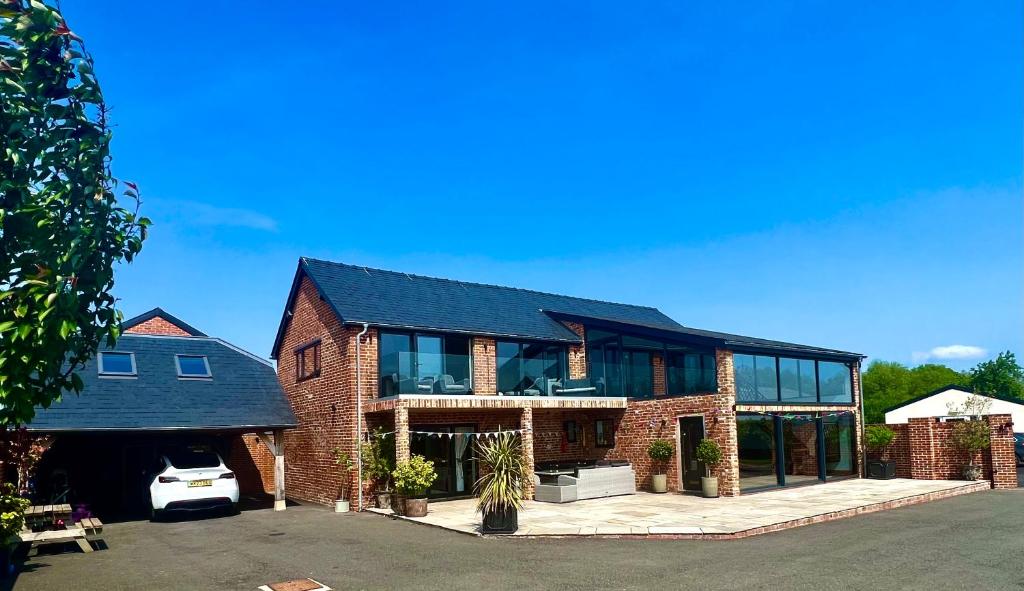 a large brick house with a lot of windows at New Converted Barn in Hereford