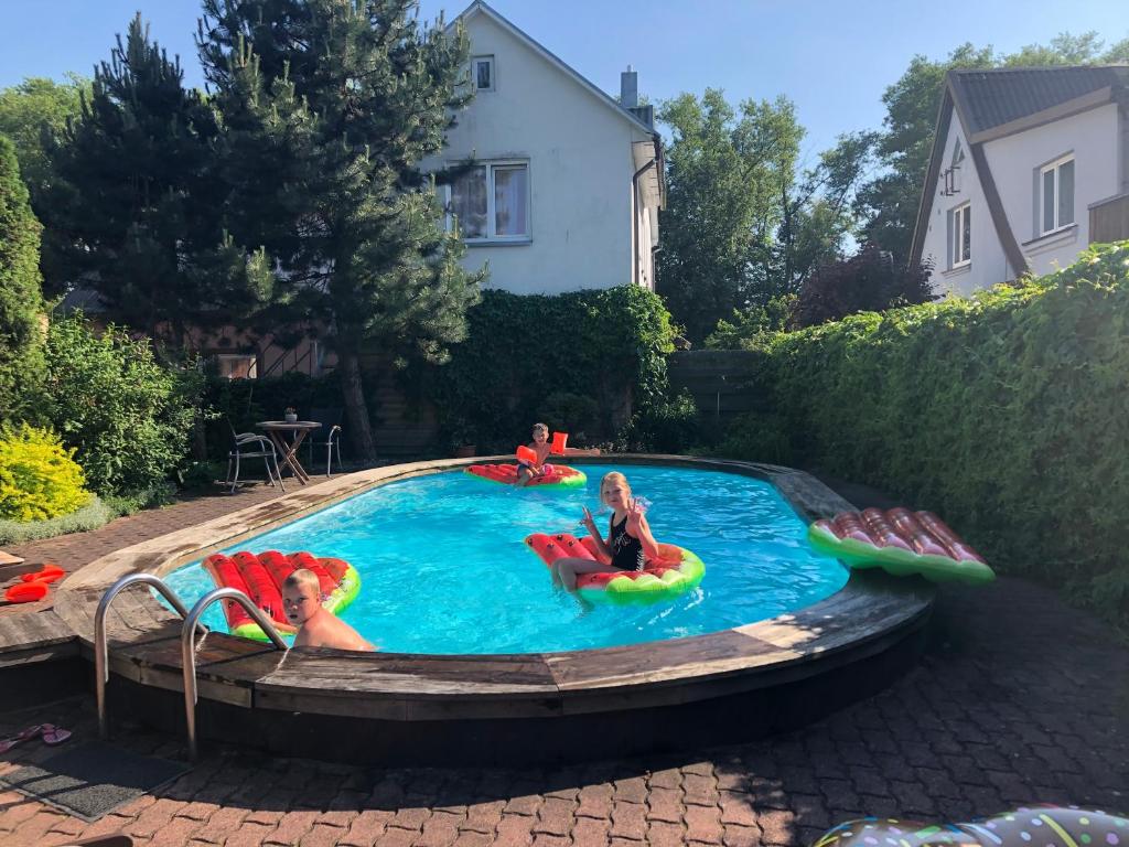 a group of people sitting in a swimming pool at Palangos Saulegraza in Palanga