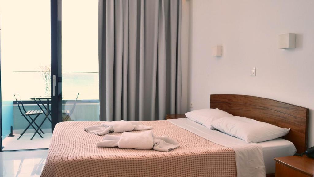 Postel nebo postele na pokoji v ubytování Poseidon Hotel