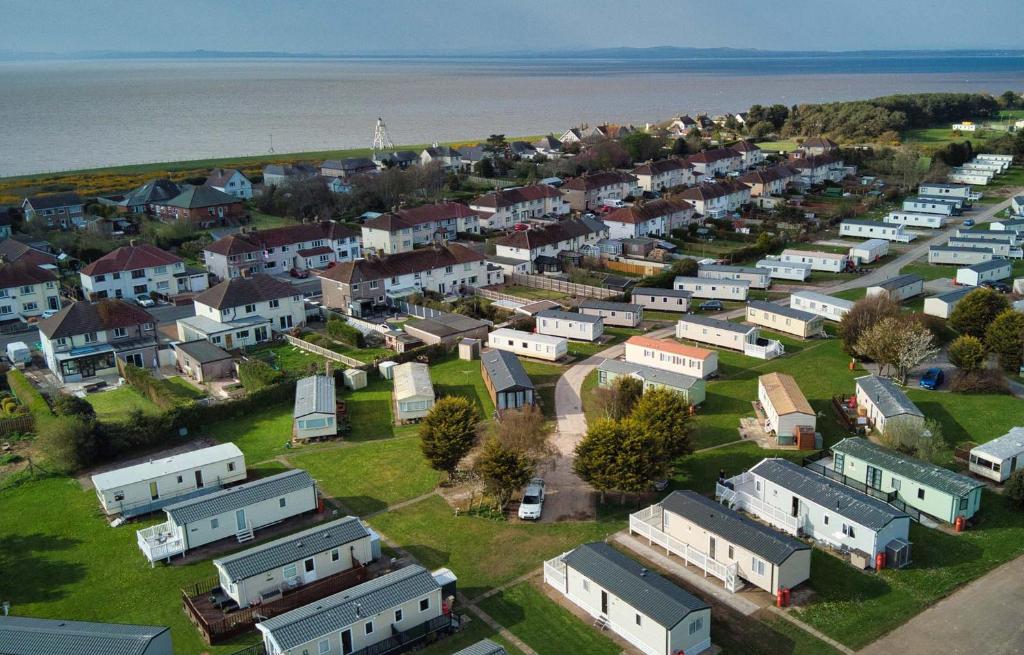 an aerial view of a town with houses and the water at Solway Holiday Park in Silloth