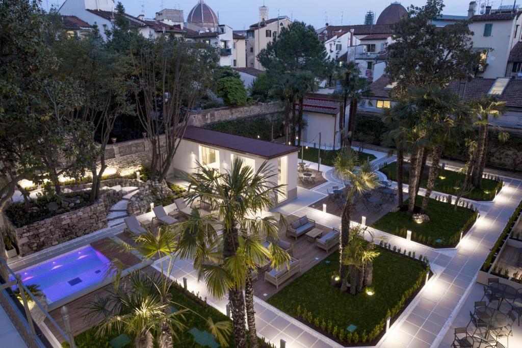 an aerial view of a courtyard with a pool and palm trees at Palazzo Castri 1874 in Florence