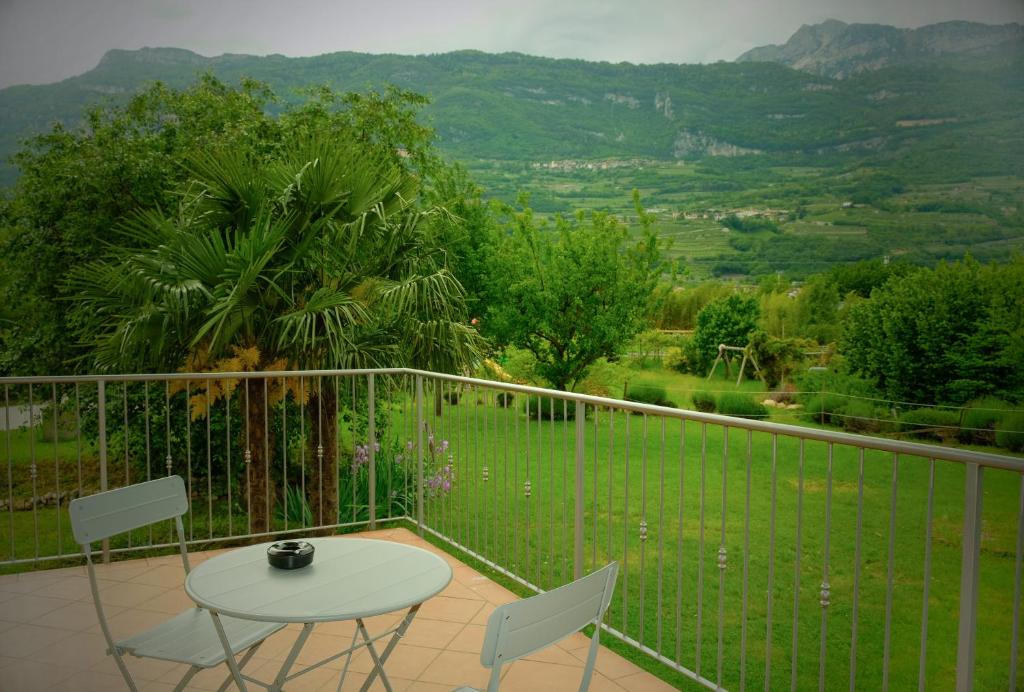 a balcony with a table and chairs and a view at Countryhouse Verso in Rovereto