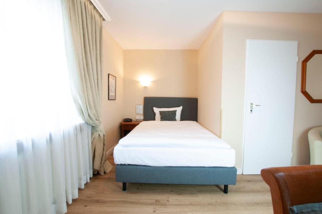 Postel nebo postele na pokoji v ubytování Hotel Altmünchen by Blattl
