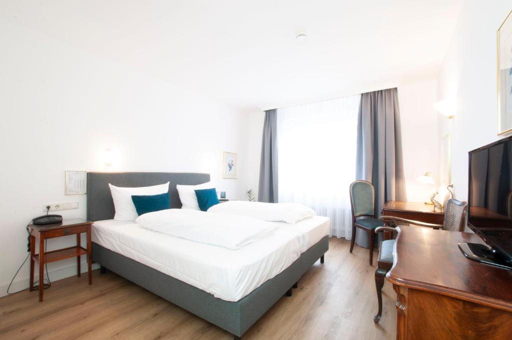Postel nebo postele na pokoji v ubytování Hotel Altmünchen by Blattl