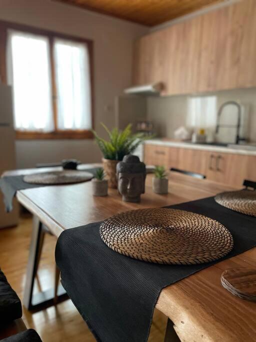 a kitchen with a wooden table with a counter top at Politis' wooden house in Vasiliki