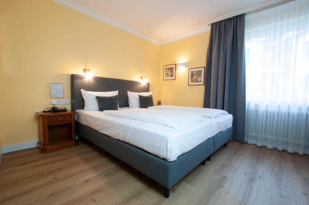 Postel nebo postele na pokoji v ubytování Hotel Altmünchen by Blattl