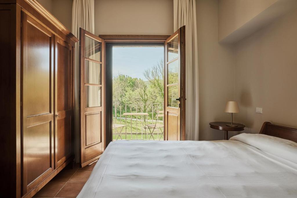 Łóżko lub łóżka w pokoju w obiekcie Agriturismo Villetta Di Monterufoli