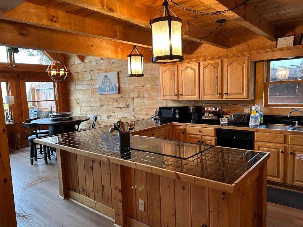 a kitchen with wooden cabinets and a large counter top at Classy Bear Cabin in Gatlinburg