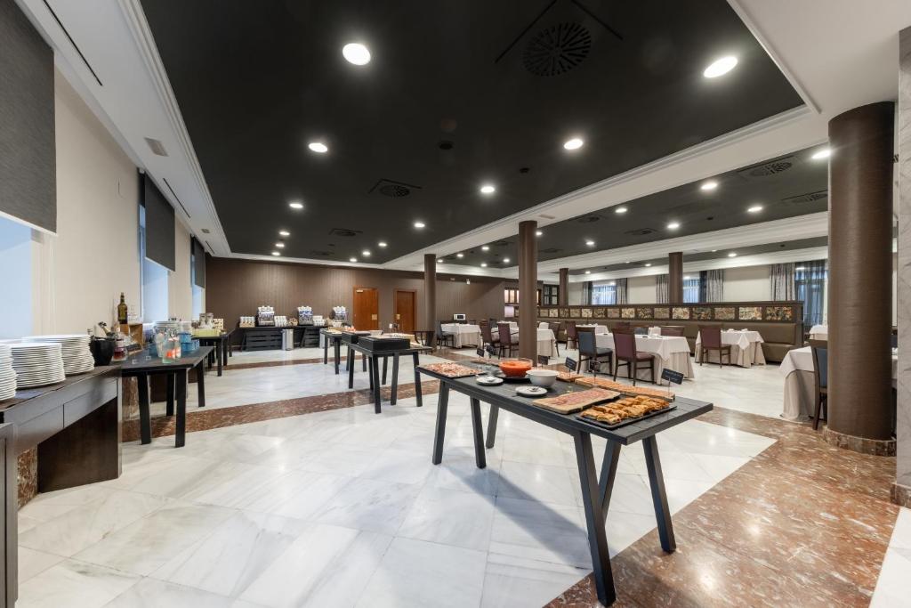 a restaurant with tables with food on them at Castilla Termal Solares in Solares