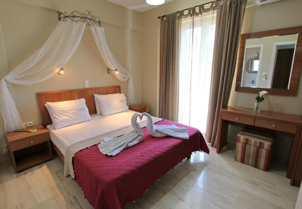 Postel nebo postele na pokoji v ubytování Vassiliki Bay Hotel