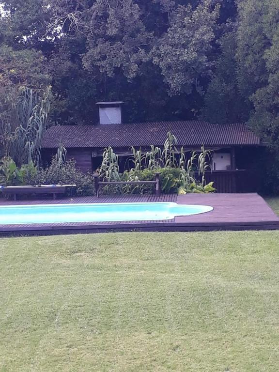 a frisbee laying on the grass in front of a house at Flor de Lis apartmento, Room 1, Room 2 in Mar del Plata