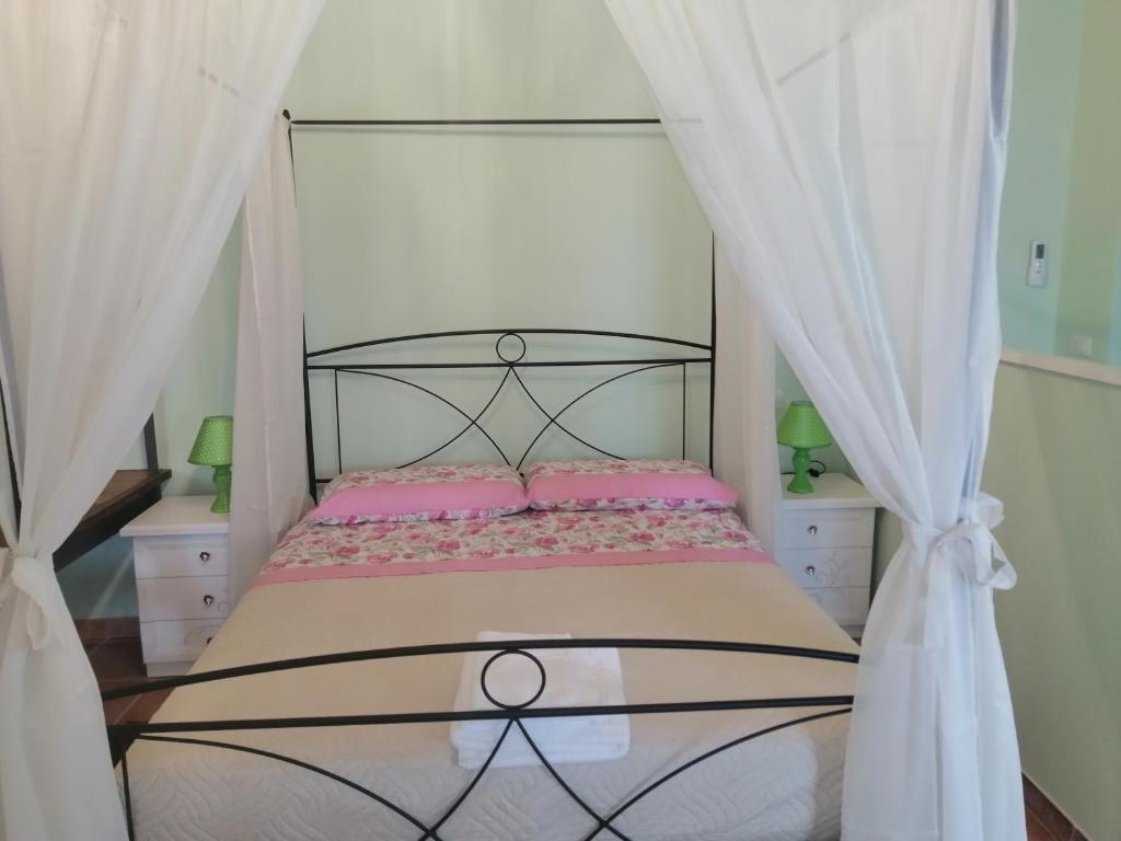 1 dormitorio con 1 cama en blanco y negro con cortinas en SPELLO ROMANTICA, en Spello