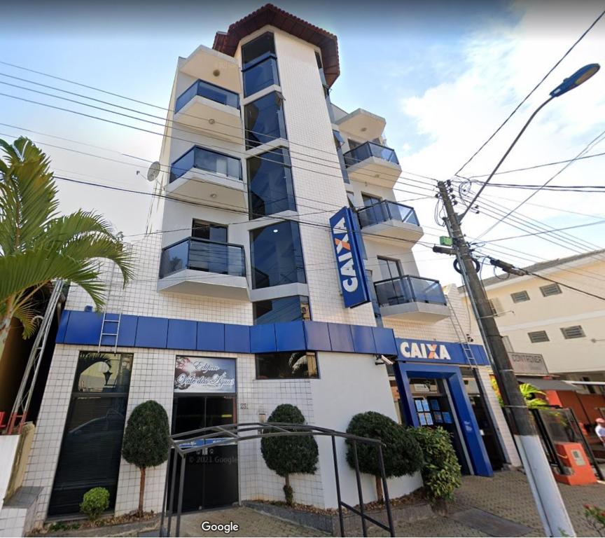 a building with a sign on the side of it at Apartamento 32 no centro de Águas de São Pedro in Águas de São Pedro