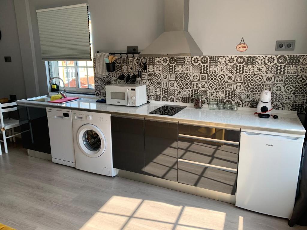 Kuchyň nebo kuchyňský kout v ubytování NOARU Apartamentos