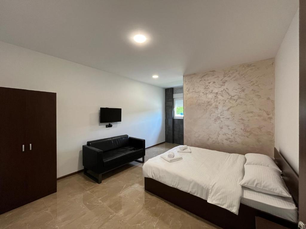 Postel nebo postele na pokoji v ubytování Apartmani Bosfor