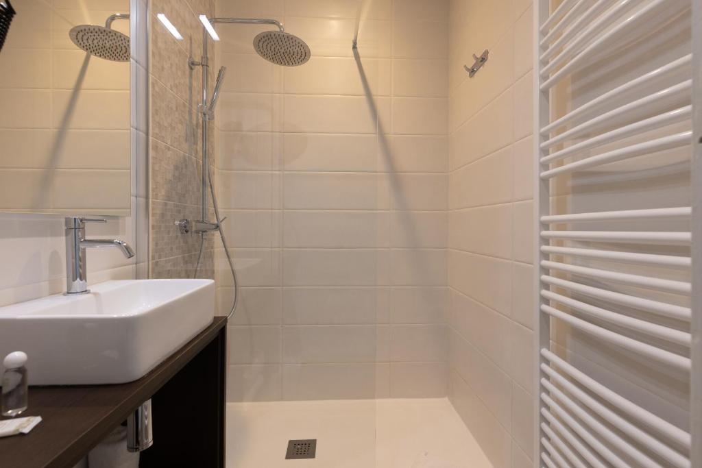 a bathroom with a sink and a shower at Brit Hotel Europ Bergerac in Bergerac